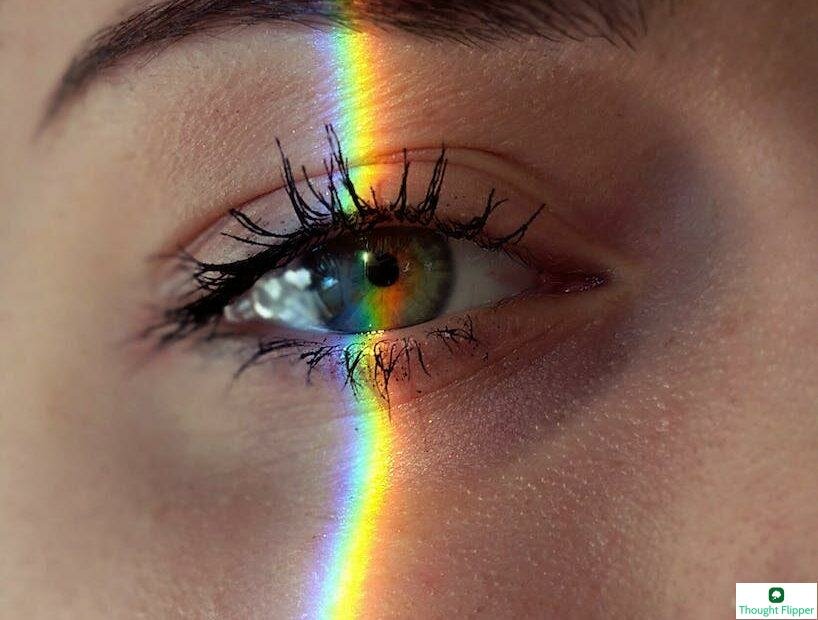 anonymous woman with rainbow light on face